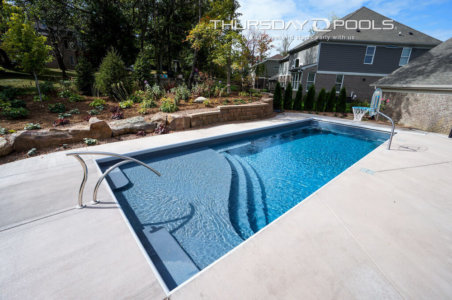 Thursday Pools side angle view of Aspen Diamond Gray pool with landscaping in background