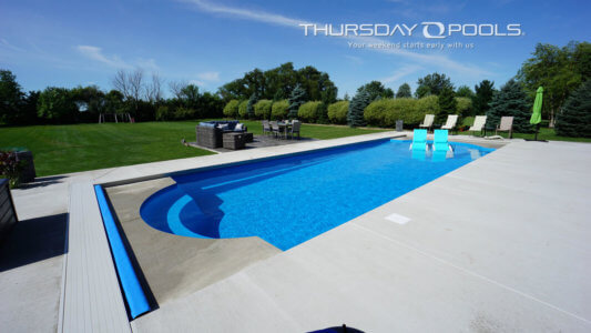 fiberglass pool with a tanning ledge