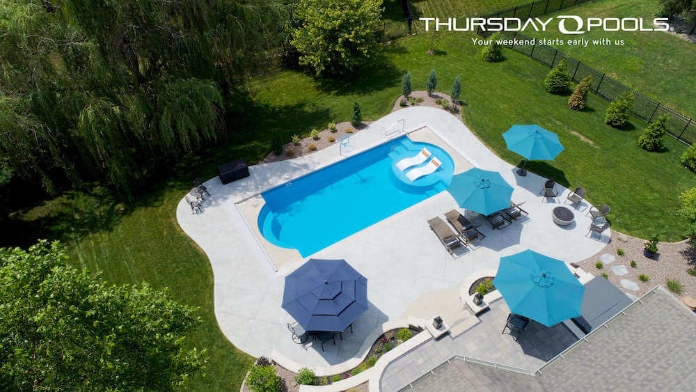 Thursday Pools aerial view of Cathedral LX pool with umbrellas and lounge chairs