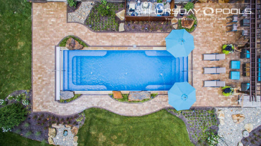Ariel view of the caribben sparkle rectangular pool with stair entry and bench seating