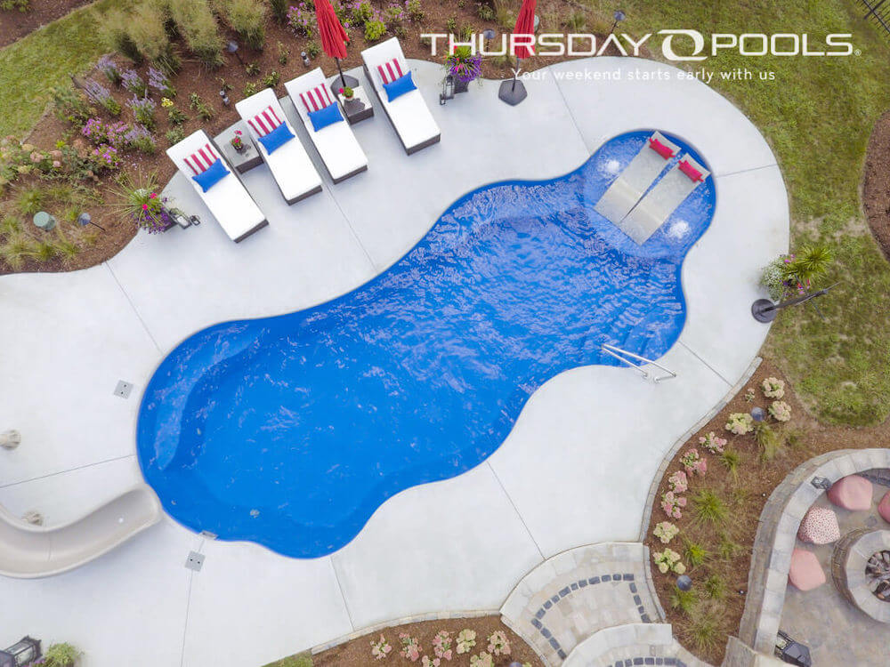 Thursday Pools aerial view of Maya Wellspring pool and two lounge chairs with red pillows
