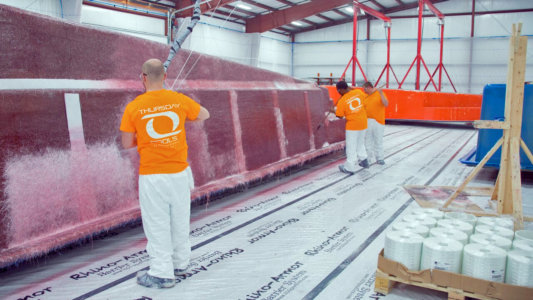 Thursday Pools man painting pool shell in warehouse