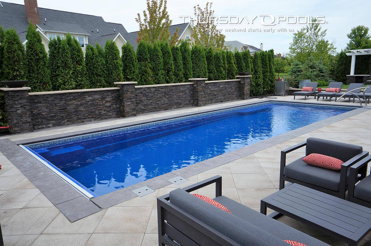 Thursday Pools Pool in backyard with ledge