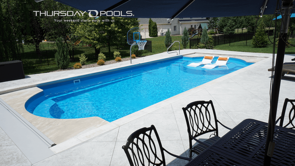 Thursday Pools Cathedral LX with lounge chairs and basketball hoop