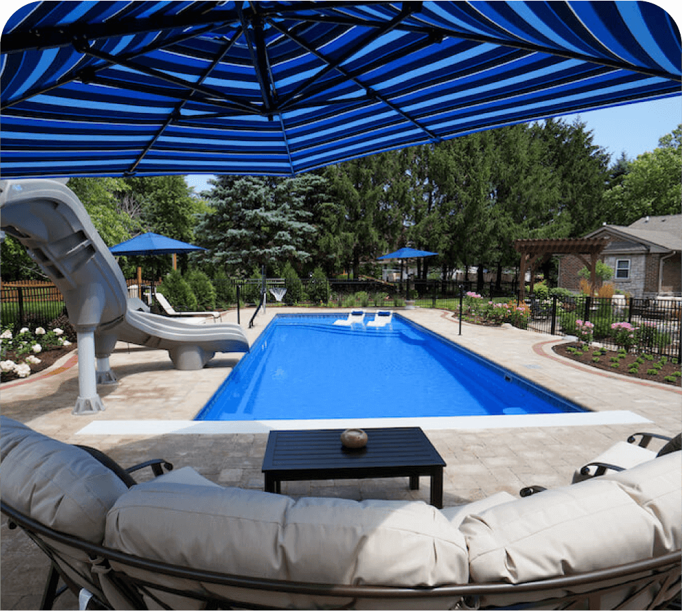 Thursday Pools blue umbrella over couch with Aspen Pool in background