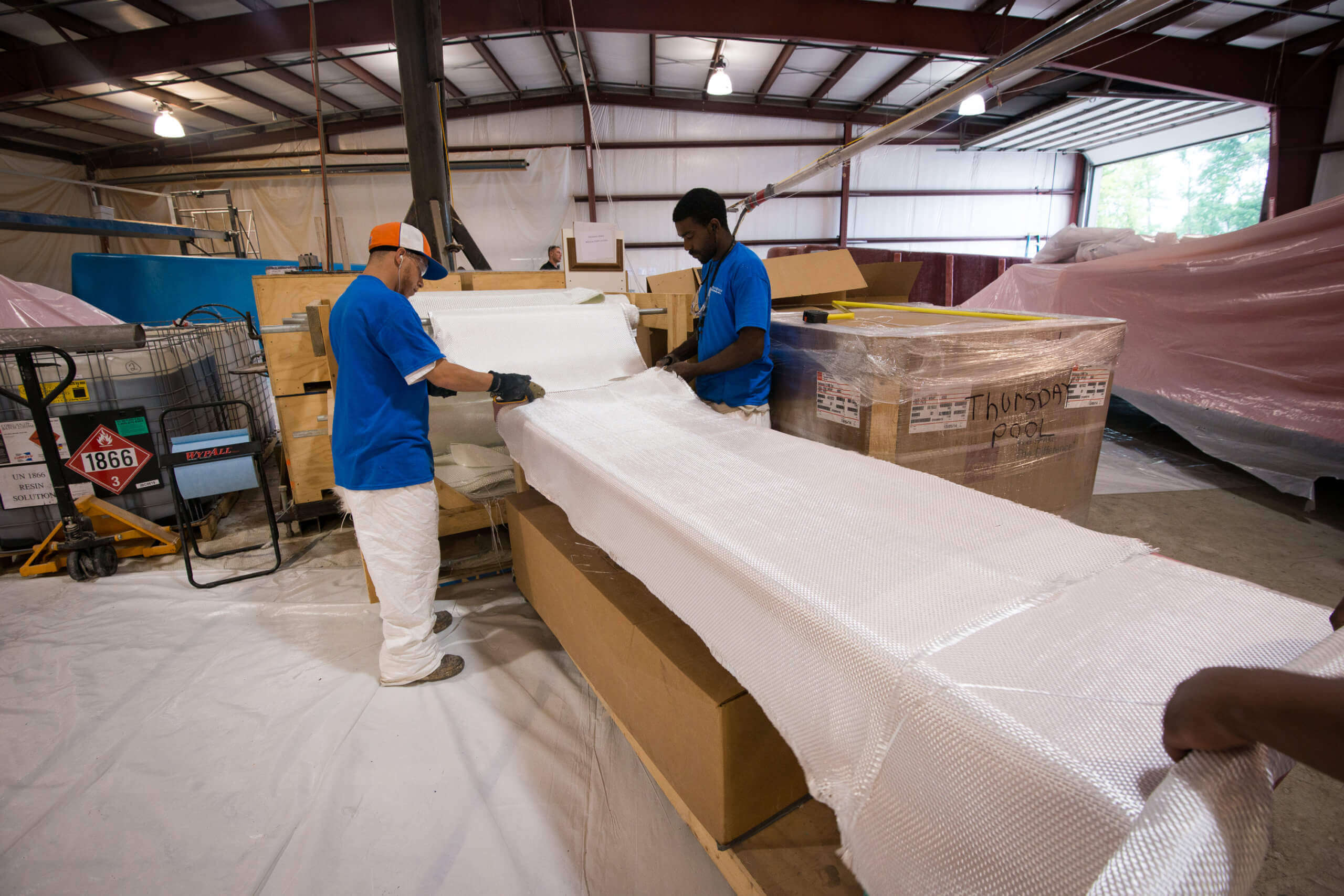 Thursday Pools workers working in warehouse