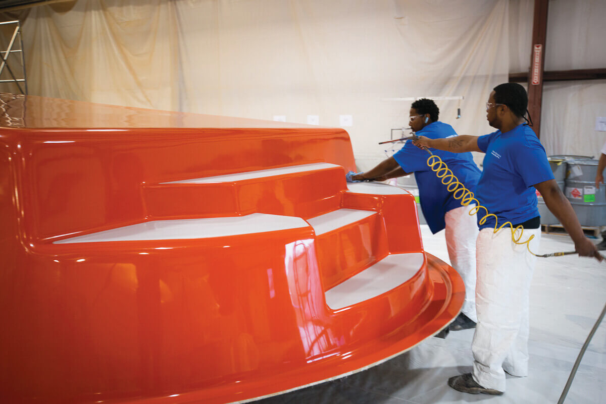 Thursday Pools people spraying pool with paint in warehouse