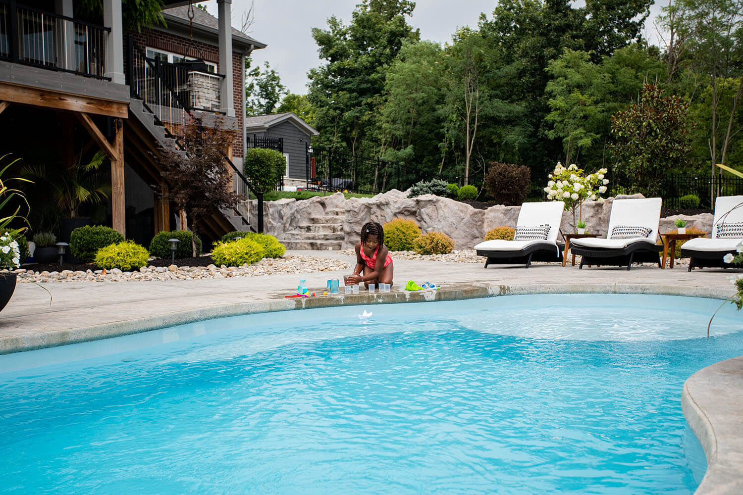 Thursday Pools kid playing in pool with dad watching