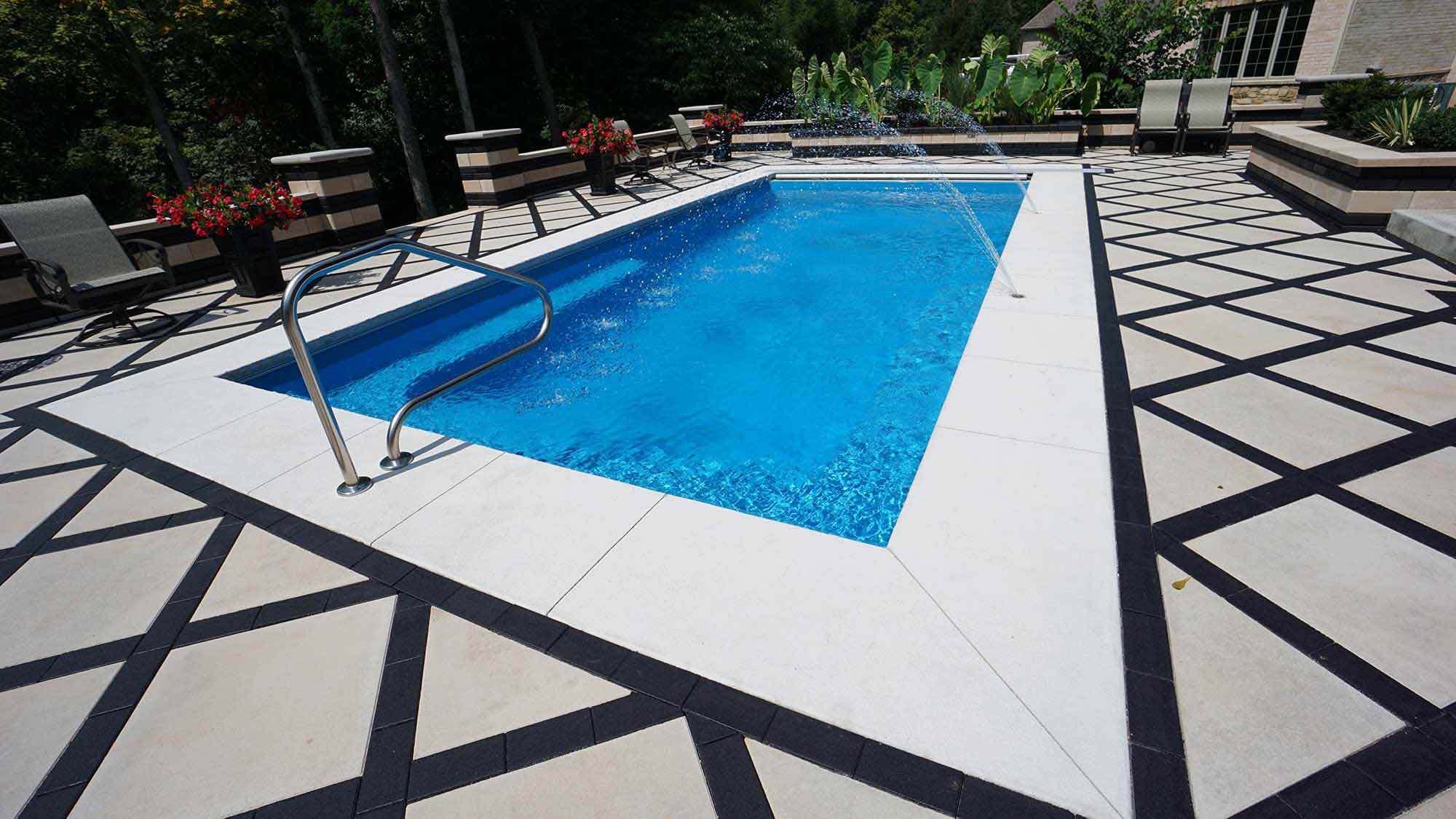 detail of the coping of a Lil Bob fiberglass pool by Thursday Pools on a black and white patio