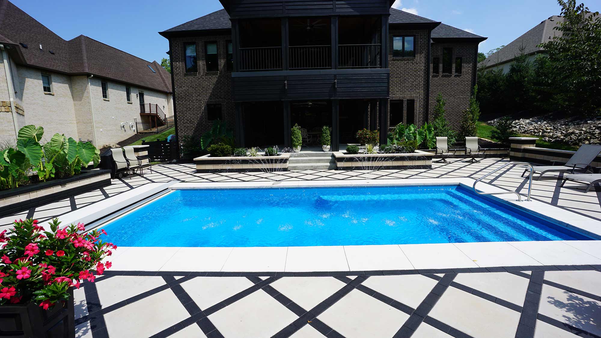 landscaped patio of a lil bob fiberglass pool by thursday pools