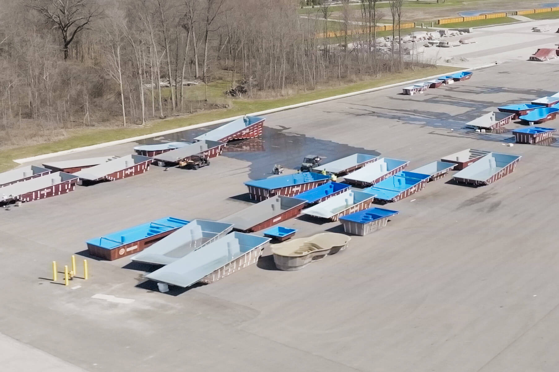 Thursday Pools Yard drone shot showing empty fiberglass pool shells